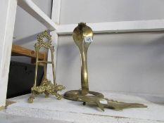 A brass cobra, brass easel and a brass fish,