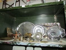 A shelf of assorted metal ware including trays.
