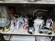 A shelf of irons, kettles etc.