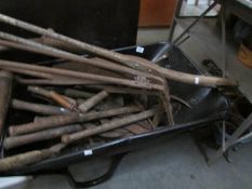A wheel barrow and garden tools.
