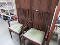 A pair of elbow chairs,.