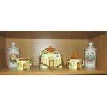 A 3 piece cottage ware tea set and a pair of lidded jars.