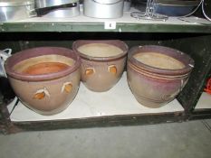 A shelf of ceramic planters.