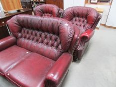 A red leather 3 piece suite.