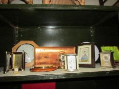 A shelf of assorted clocks.