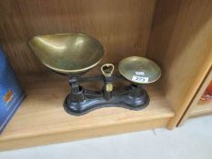 A set of kitchen scales with brass pans.