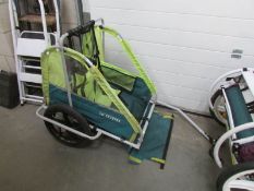 A bicycle trailer for a child.