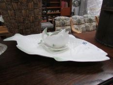 A Shorter fish serving plate and sauce boat with stand.