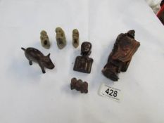 A carved Chinese figure a/f, 3 stone monkeys, a stone pig etc.