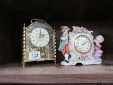 An anniversary clock (feathe damaged) and a ceramic figural clock.