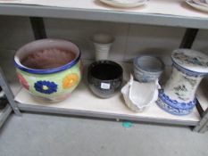 A shelf of assorted plant pots.