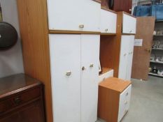 A white bedroom combination unit and 3 drawer chest.