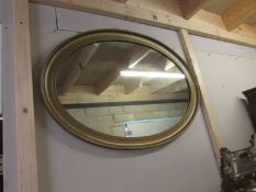 A large oval framed mirror.