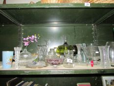 A shelf of assorted glass ware.