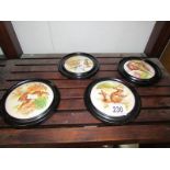 4 framed pot lids depicting animals and birds.