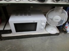 A microwave oven and a fan.