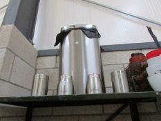 A stainless steel bin and storage jars,.