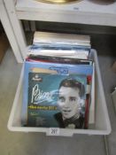 A box of LP records and 2 Bing Crosby 78rpm records.