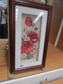 A framed and glazed decoupage of poppies.