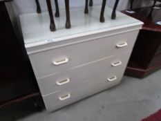 A white 3 drawer chest.