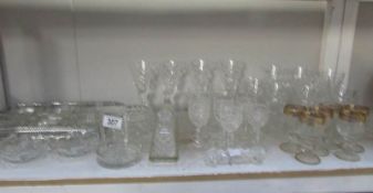 A shelf of assorted glass ware.