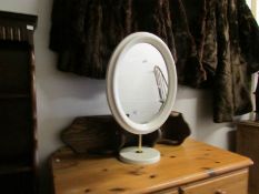A white dressing table mirror and a wall shelf.