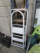 A quantity of garden tools and step ladders.