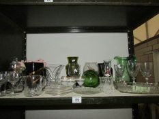 A shelf of assorted glass ware.