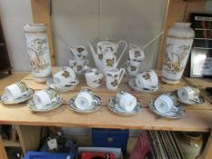 A coffee set, 6 coffee cans with saucers and 2 vases.