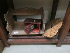 A wooden book rack, cigarette dispenser etc.