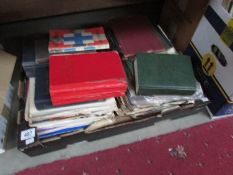 A box of assorted books.