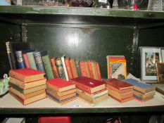 A shelf of assorted vintage books.