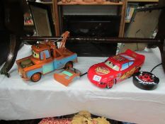A Lightning McQueen and a Mater remote controlled cars.
