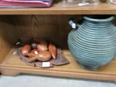 A shelf of wooden fruit, vase etc.
