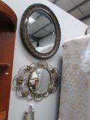 A wrought iron mirror and one other.