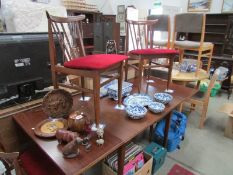 A drop leaf dining table and 4 chairs.