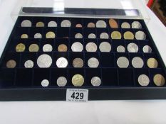 A collector's tray of assorted coins.