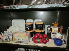 A shelf of miscellaneous including teapots, storage jars etc.