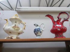 An ornamental teapot and 2 jugs.