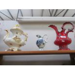 An ornamental teapot and 2 jugs.