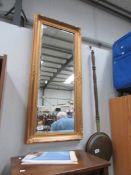 A gilt framed bevel edged mirror.