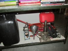 A shelf of miscellaneous car items including jack, foot pump etc.