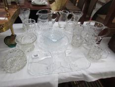 A mixed lot of glassware including jugs, vases, bowls, trays etc.