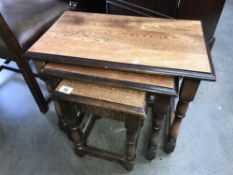 A nest of 3 oak tables.