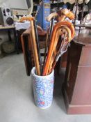 A ceramic stick stand containing walking sticks.