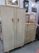 A wardrobe with matching chest of drawers and stool.