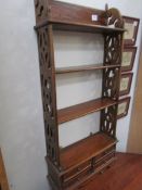 A nice four shelf narrow book case.