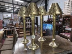 4 brass candle lamps with brass shades.