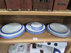 A set of 24 plates by Harrods in white with blue edging and lion emblem with latin motto 'Fide Sed