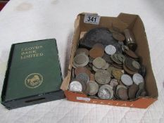 A mixed lot of coins and a LLoyds bank money box.